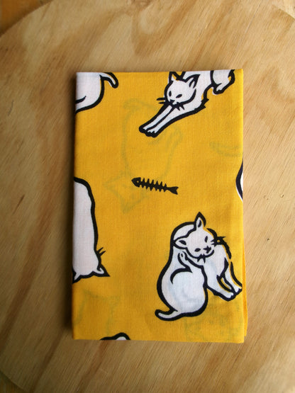 Cotton tenugui hand towel featuring cat-themed design by Kamawanu, showcasing colorful cat illustrations on white fabric.