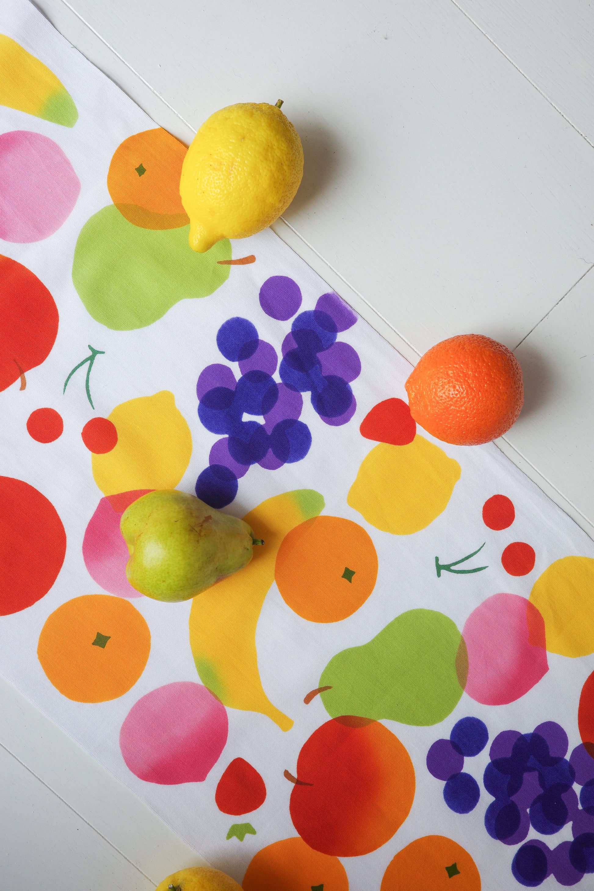 Colorful fabric tenugui with fruit pattern by Kamawanu, featuring vibrant illustrations of various fruits on traditional Japanese cloth.