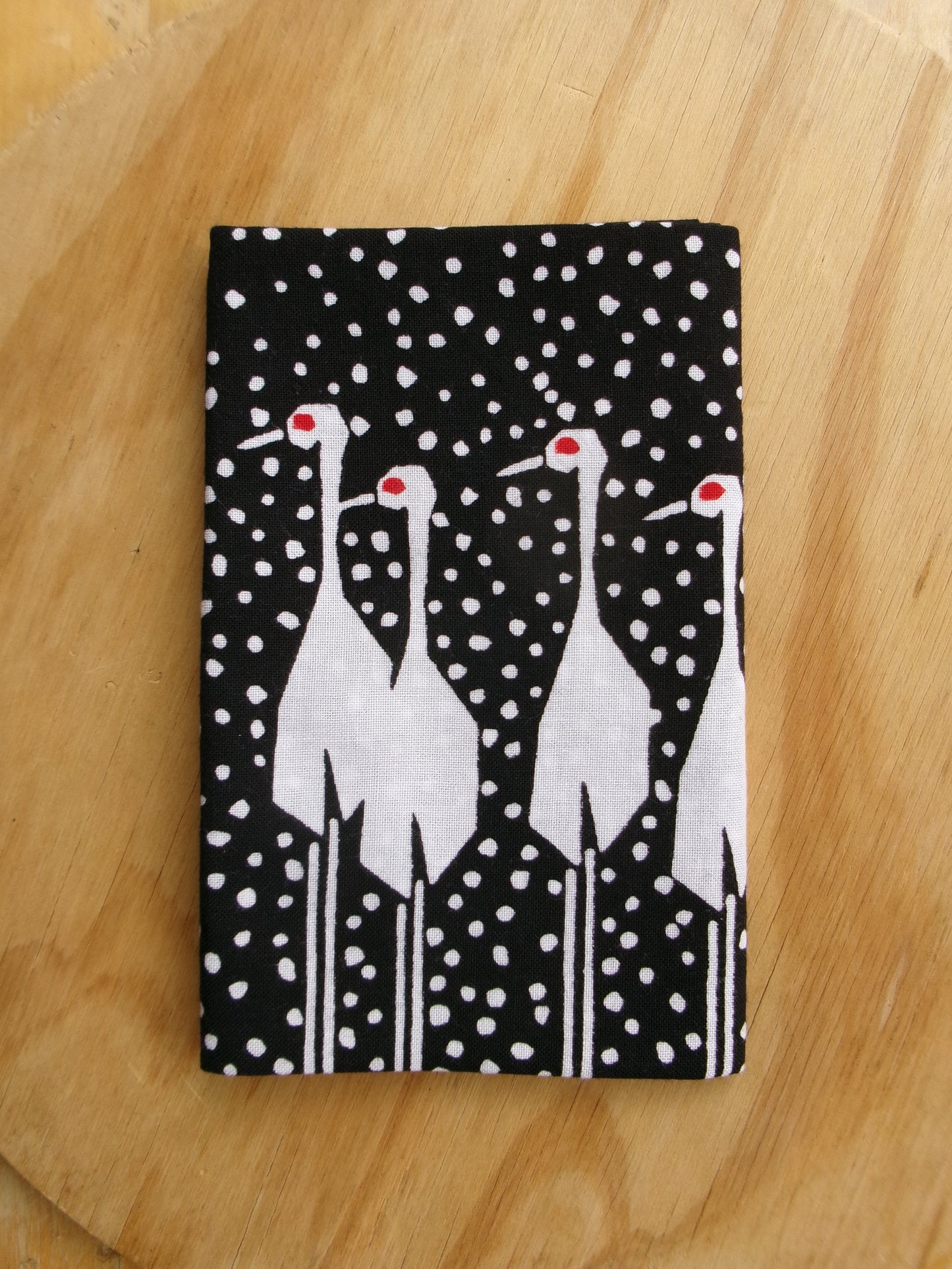 Traditional Japanese tenugui towel featuring a snow crane design by Kamawanu, showcasing intricate crane and snowflake patterns.