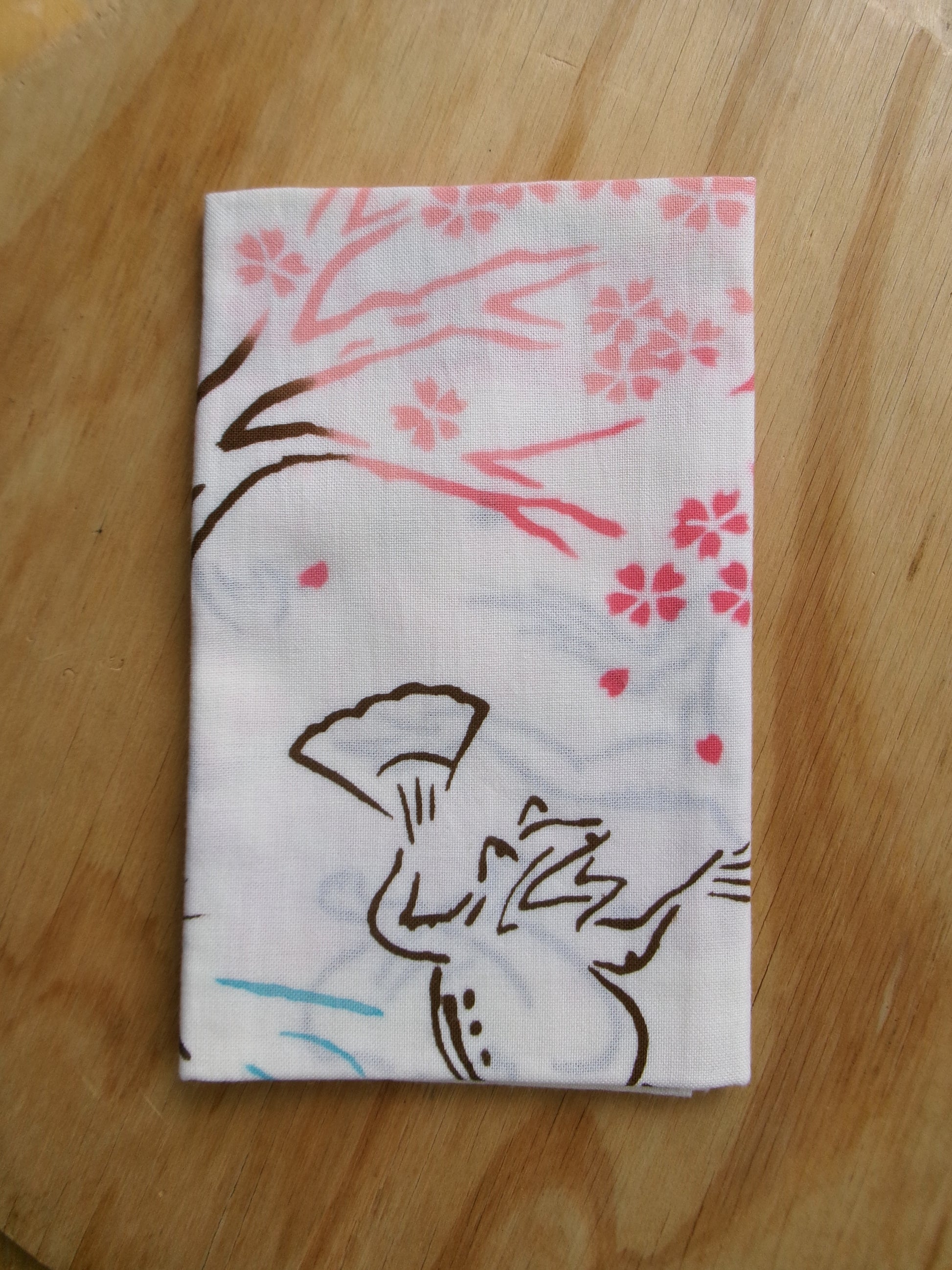 Japanese tenugui hand towel with cherry blossom and floral design by Kamawanu, perfect for hanami and spring celebrations.