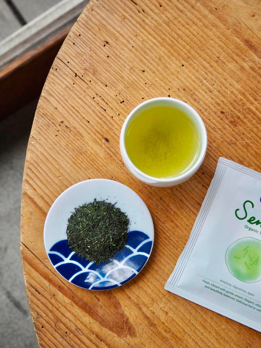 Organic Sencha drip bag from CIBI TOKYO STORE, showing individually wrapped green tea tea bags with fresh green tea leaves.
