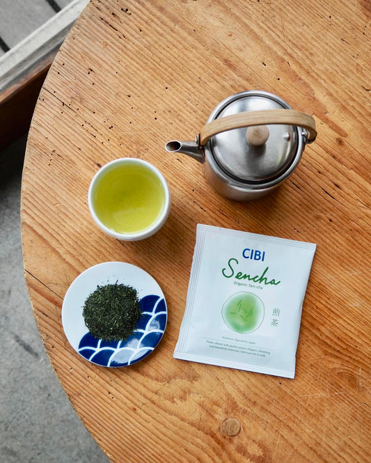 Organic Sencha drip bag tea from CIBI TOKYO STORE, showing green tea leaves and brewing in a clear cup.