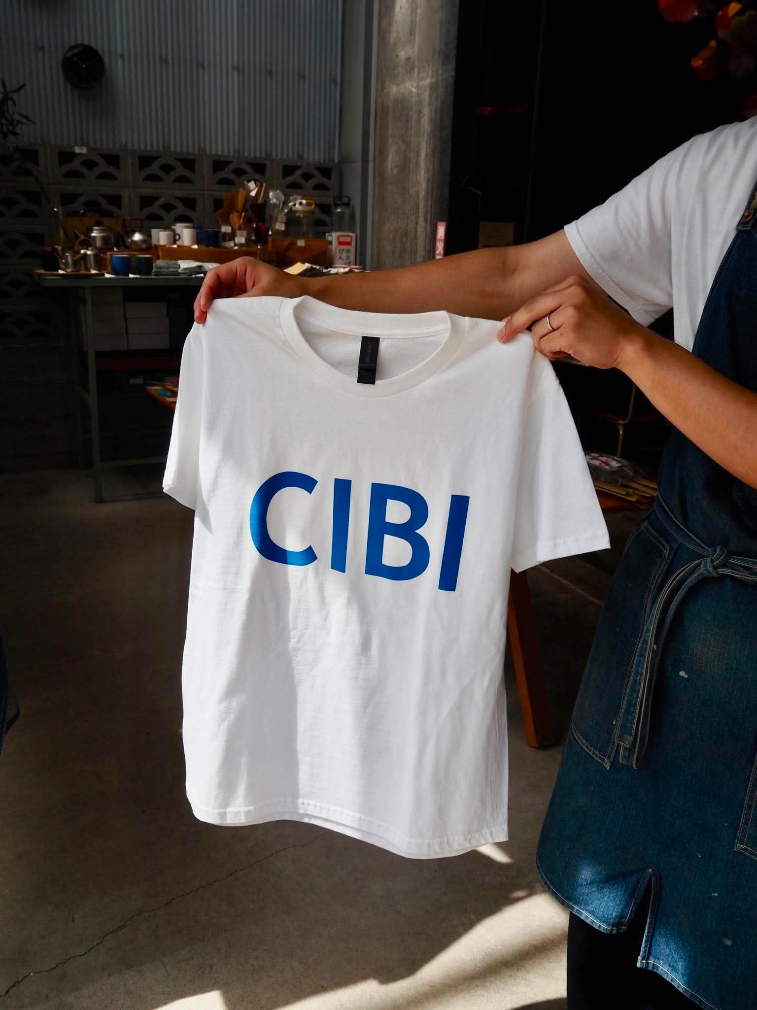 CIBI TOKYO STORE casual T-shirt with graphic design, white fabric, and relaxed fit, displayed flat on a neutral background.