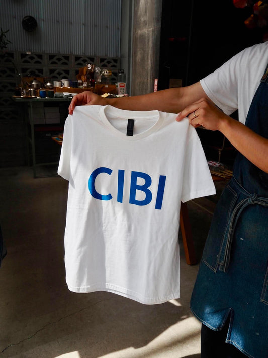 CIBI TOKYO STORE casual T-shirt with graphic design, white fabric, and relaxed fit, displayed flat on a neutral background.