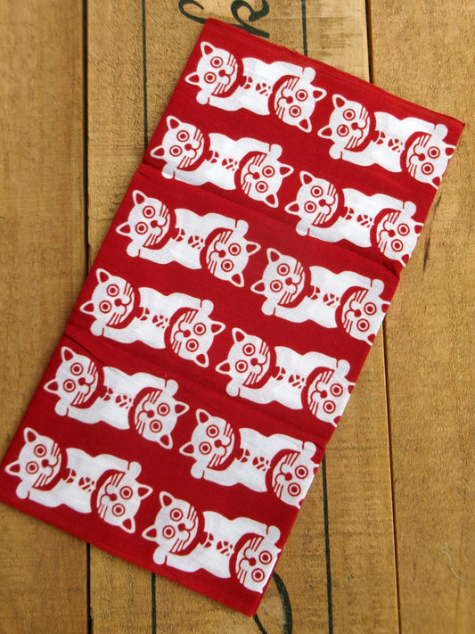 Japanese tenugui featuring lucky cat and traditional patterns by Kamawanu, showcasing intricate textile design and vibrant colors.