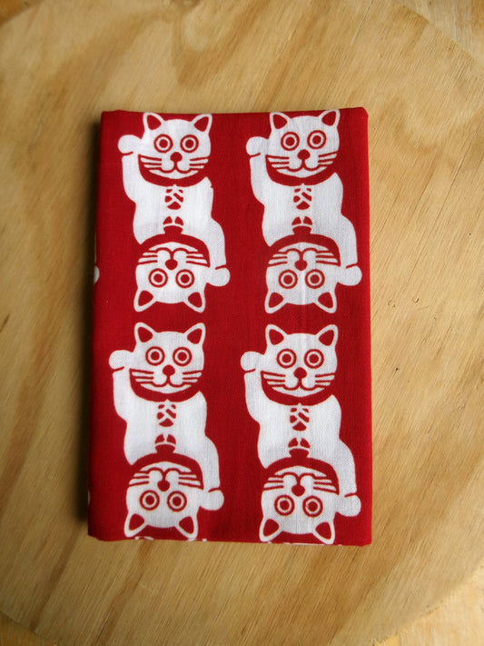 Traditional tenugui cloth featuring lucky cat motifs, crafted by Kamawanu, showcasing detailed hand-painted feline designs.