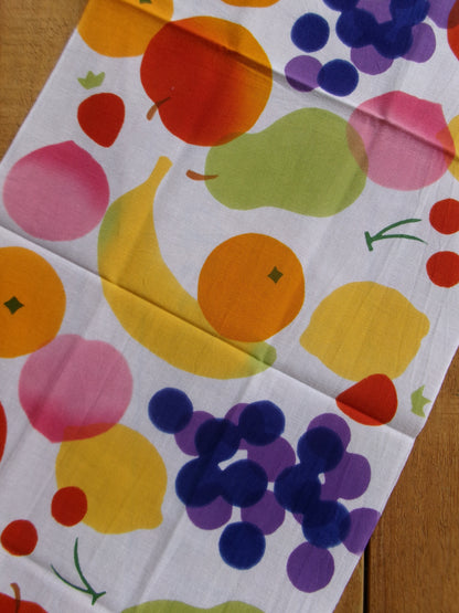 Japanese tenugui cloth with colorful fruit pattern by Kamawanu, showcasing vibrant illustrations of various fruits.